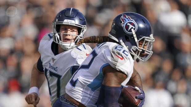 Tennessee Titans quarterback Ryan Tannehill (17) hands the football off to running back Derrick Henry (22) during the first quarter against the Oakland Raiders at Oakland Coliseum.